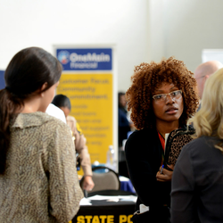 students at a job fair talking to potential employers