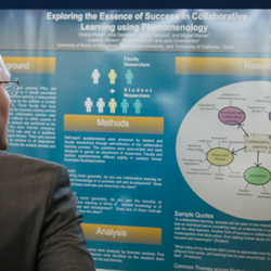 a student at STARS talking about his research to an audience member