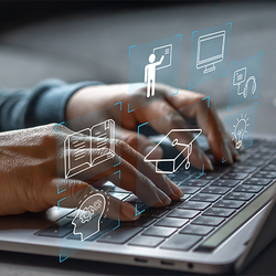 Hands typing on a laptop with digital icons floating above.