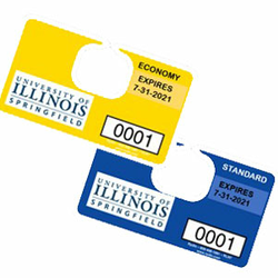 Two parking decals for the University of Illinois Springfield, one yellow, one blue.