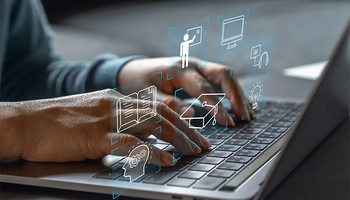 Hands typing on a laptop with digital icons floating above.
