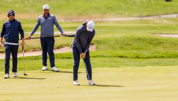 Julien Babineau golfing in gray and blue UIS gear