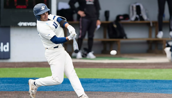 Tommy Atkinson playing baseball in white UIS uniform