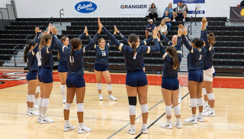 UIS Volleyball team on court together before a match