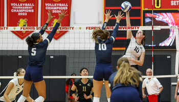 UIS Volleyball players go up for a block