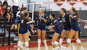 UIS Volleyball team celebrating on court at Ferris State tournament
