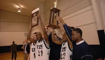 UIS Basketball Players Hoisting Trophy