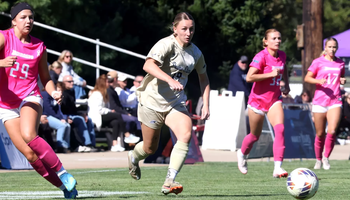 Bridget Lyons playing soccer in UIS gold