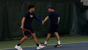 Lin En Tan and Pablo Herrera high five during doubles match