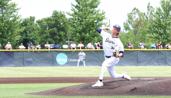 Mark DeCicco pitching at UIS Baseball Field in white uniform