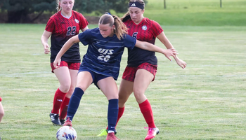 Elyse Severson playing soccer in UIS blue