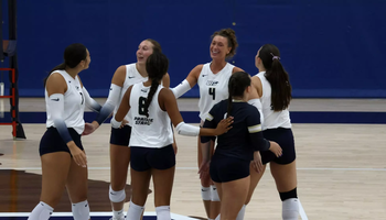 Volleyball huddle including Kaitlyn Taylor