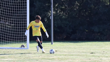 UIS goalkeeper Kevin Kardel kicks ball, yellow jersey