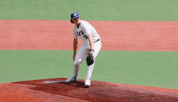 Ben Benoit pitching in white UIS uniform