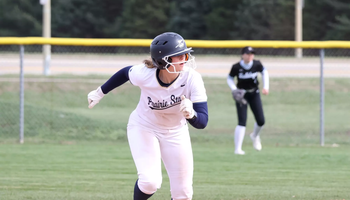 Rachel McMullen running the bases in white UIS softball uniform