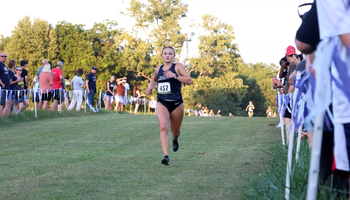 Marissa Roggensack running cross country in UIS blue