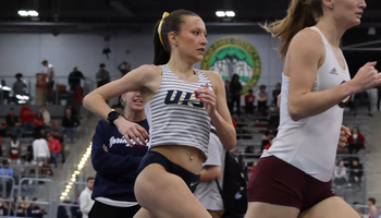 Maddie Miller racing mile in indoor track