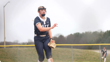 Calista Stahlhut pitching in blue UIS uniform