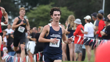 Joey Karlesky running cross country in blue UIS uniform