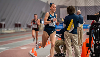 Madelyn Miller-Ross racing in blue UIS uniform at GLVC Indoor Championship