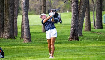 Elaine Grant golfing in UIS blue and white at GLVC Championship