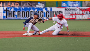 Noah Caceres playing second base in gold baseball uniform
