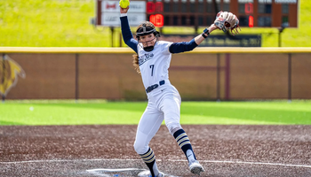 Rosie Bartletti pitching in white uniform in GLVC Tournament