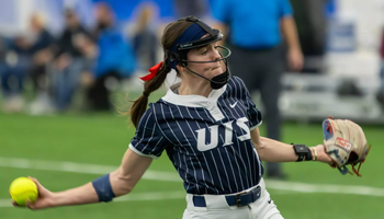 Rosie Bartletti pitching in blue UIS uniform