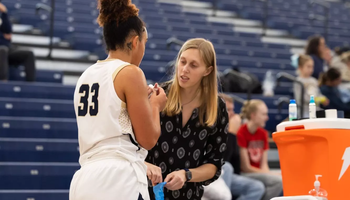 Abby Kain, athletic trainer attending to a student-athlete