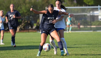 Alaina Stock playing soccer in blue UIS uniform
