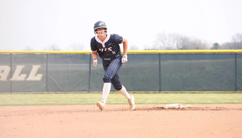 Bailey Masching baserunning in blue UIS softball uniform