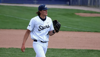 Ben Benoit pitching in white UIS baseball uniform