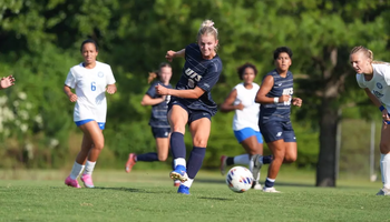 Rachel Riney kicking soccer ball during a game