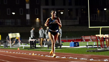 Mackenzie Billard running outdoor track in the evening in blue UIS uniform