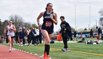 Allison Thompson running track in blue UIS uniform