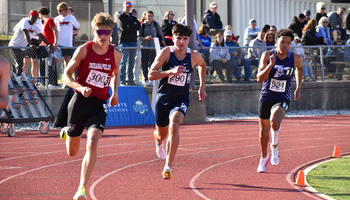 River Derby running outdoor track in blue UIS uniform