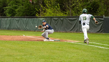 Drew Ezard playing first base in blue UIS baseball uniform