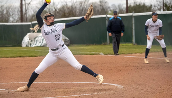Calista Stahlhut pitching in white UIS uniform
