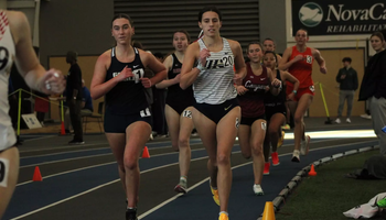 Mackenzie Billard running indoor track in white UIS uniform