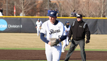 Austin Loberger pitching in white UIS uniform