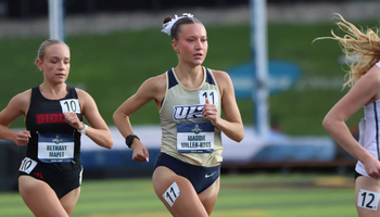 Maddie Miller-Ross running track in gold UIS uniform
