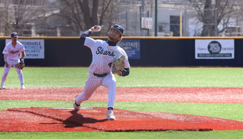 Trey Carter pitching in white UIS baseball uniform