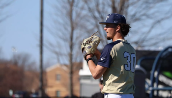 Richie Snider pitching in gold UIS uniform