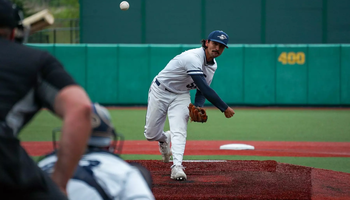 Esteban Hernandez pitching in white UIS uniform