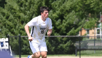Jacob Shaw playing soccer in white UIS uniform