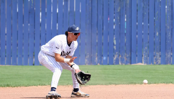 Jesse Contreras playing shortstop in white UIS baseball uniform