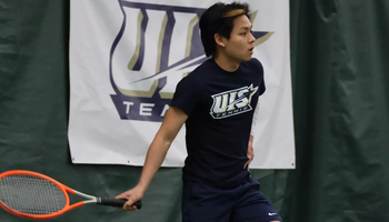 LIN EN TAN PLAYING TENNIS, FEATURING UIS TENNIS BANNER