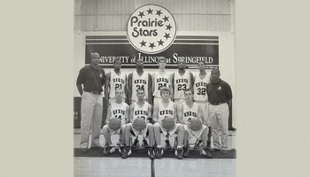 A newspaper clipping of head UIS Basketball Coach Kevin Gamble and his team