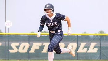 Rachel McMullen running the bases in blue UIS softball uniform