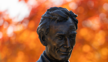 Statue of Abe Lincoln with orange flower in his lapel